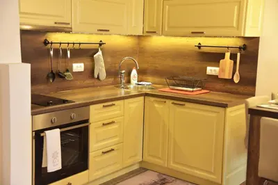 a kitchen with yellow cabinets and a sink at Apartment Mint in Kopaonik