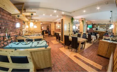 a restaurant with a dining room with tables and chairs at Apartment Mint in Kopaonik
