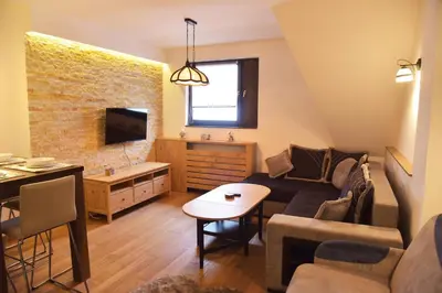 a living room with a couch and a table at Apartment Mint in Kopaonik