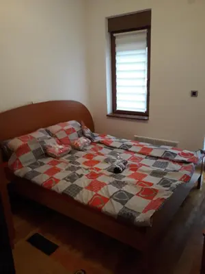 a bed with a quilt on it in a bedroom at Apartment Hedonic in Vrnjačka Banja
