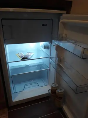 an open refrigerator with its door open and itsartmentsearchangering at Apartment Hedonic in Vrnjačka Banja