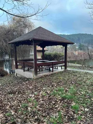 a picnic shelter with a picnic table in a park at Relax Apartment in Vrnjačka Banja