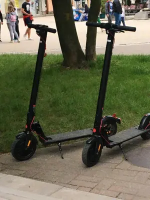 two scooters parked on the side of a sidewalk at Relax Apartment in Vrnjačka Banja