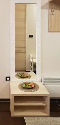 a bathroom with a mirror and a table with a plate at Shining Apartment Milmari M11 in Kopaonik