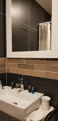 a bathroom with a sink and a toilet and a mirror at Shining Apartment Milmari M11 in Kopaonik