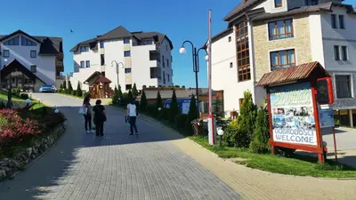 a group of people walking down a street at Shining Apartment Milmari M11 in Kopaonik