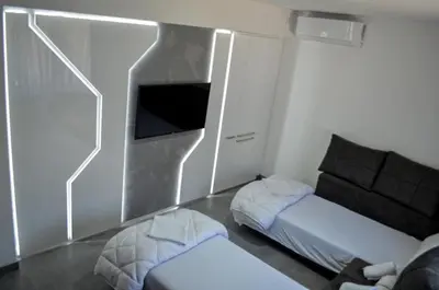 a living room with a tv and a couch at Apartments Good Night in Niš