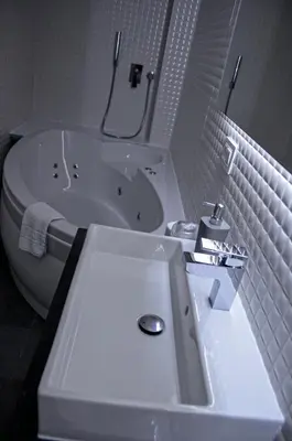 a bathroom with a sink and a tub and a toilet at Apartments Good Night in Niš