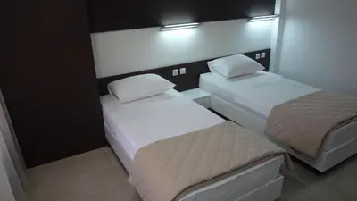 two beds in a small room with two beds sidx sidx sidx at Apartments Good Night in Niš