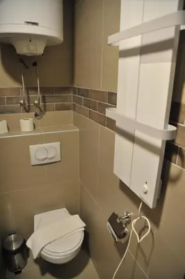 a small bathroom with a toilet and a phone at Apartments Milmari M 6.7.8 in Kopaonik