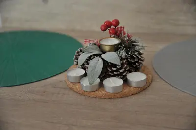 a miniature christmas tree and candles on a table at Apartments Milmari M 6.7.8 in Kopaonik
