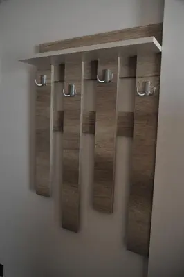 a shelf on a wall with wooden boards at Apartments Milmari M 6.7.8 in Kopaonik