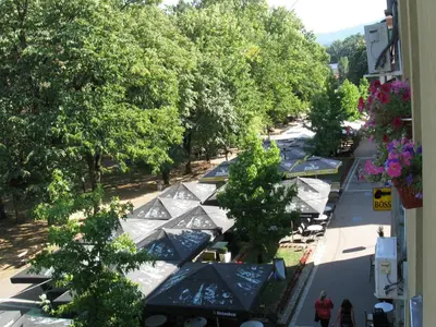 an overhead view of a street with trees and umbrellas at Apartments Passage in Vrnjačka Banja