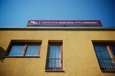 a building with three windows and a sign on it at Apartments Passage in Vrnjačka Banja