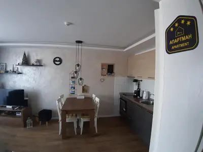 a kitchen and dining room with a table and chairs at Apartman Dragana Kopaonik in Kopaonik