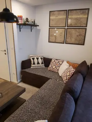 a living room with a couch with pillows on it at Apartman Dragana Kopaonik in Kopaonik