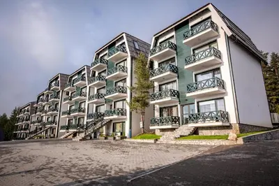 a building with balconies on the side of it at Apartman Dragana Kopaonik in Kopaonik