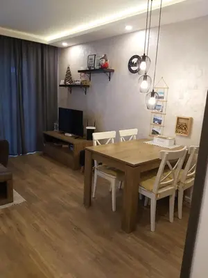 a dining room with a wooden table and chairs at Apartman Dragana Kopaonik in Kopaonik