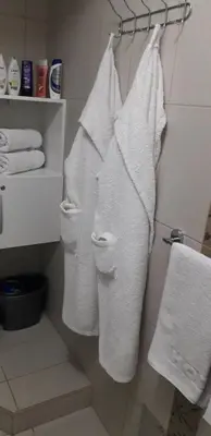 a group of towels hanging on a rack in a bathroom at Stan Na Dan in Niš