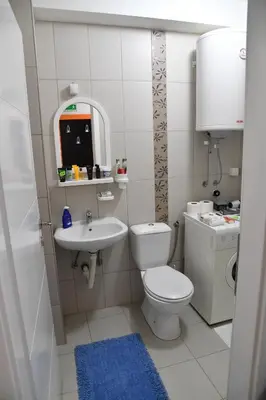 a small bathroom with a toilet and a sink at Stan Na Dan in Niš