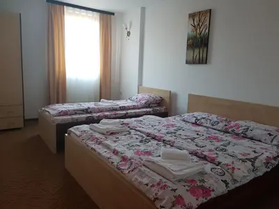 two twin beds in a room with a window at SkiTime Apartment in Kopaonik