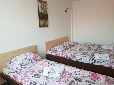two beds sitting next to each other in a bedroom at SkiTime Apartment in Kopaonik
