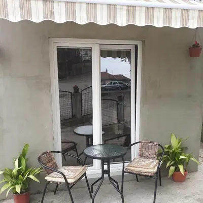 a patio with a table and chairs on a patio at Adrijana 1 Apartmani in Vrnjačka Banja