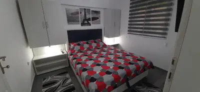 a small bedroom with a bed in a room at Adrijana 1 Apartmani in Vrnjačka Banja