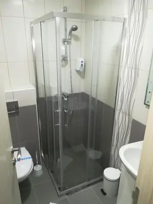 a bathroom with a shower with a toilet and a sink at Karavan 123 in Raška