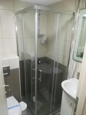 a bathroom with a shower with a toilet and a sink at Karavan 123 in Raška