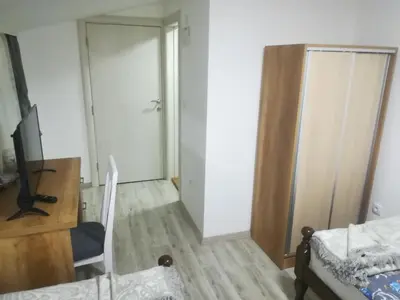 a room with a bed and a desk and a mirror at Karavan 123 in Raška