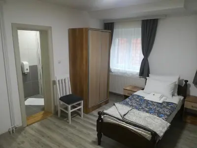 a bedroom with a bed and a chair in it at Karavan 123 in Raška