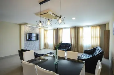 a living room with a table and a dining room at City Center Apartments in Pirot