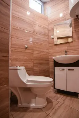a bathroom with a toilet and a sink at City Center Apartments in Pirot
