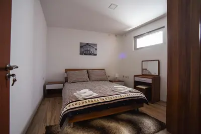 a bedroom with a bed with two towels on it at City Center Apartments in Pirot