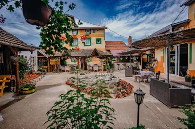 a street in a town with buildings and a fountain at Gros Hotel - Leskovac in Leskovac