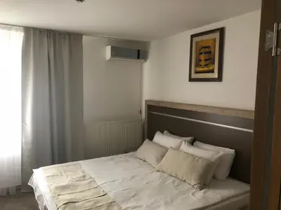 a bed with white sheets and pillows in a bedroom at Gros Hotel - Leskovac in Leskovac