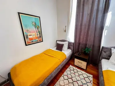 a small room with a bed and a couch at The Only One Apartments in Niš