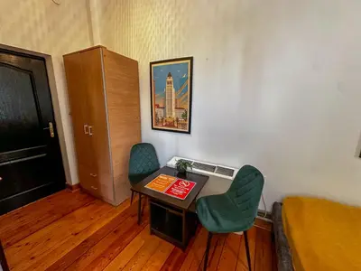 a small room with a table and two chairs at The Only One Apartments in Niš