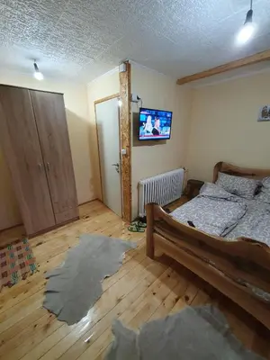 a bedroom with a bed and a tv on the wall at Smeštaj 