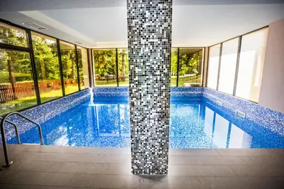 a swimming pool with mosaic tile on the sides at A Hoteli - Hotel Slatina in Vrnjačka Banja