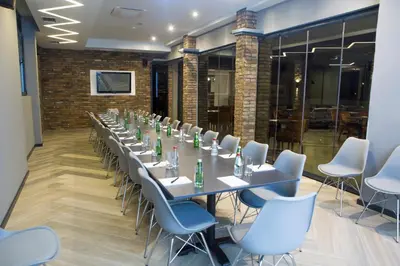a conference room with a long table and chairs at A Hoteli - Hotel Slatina in Vrnjačka Banja