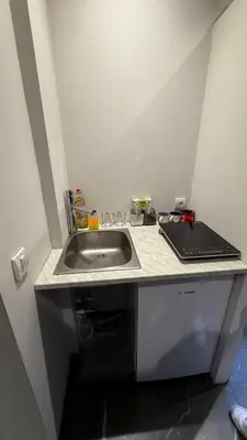 a kitchen with a sink and a laptop on a counter at Konak Garavi sokak in Kuršumlija