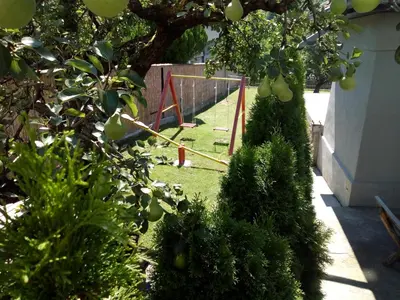 a garden with a swing set in the yard at Konak Garavi sokak in Kuršumlija