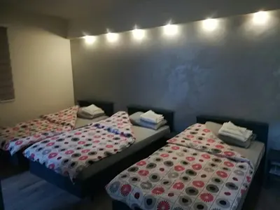 two twin beds in a room with at Konak Garavi sokak in Kuršumlija