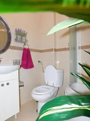 a bathroom with a toilet and a sink at Velvet Lux in Niš