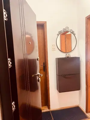 a bathroom with a door and a mirror at Sokobanja Apartman Aleksa in Soko Banja
