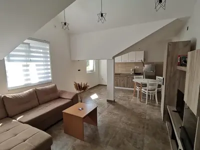 a living room with a couch and a table at Podinario in Soko Banja