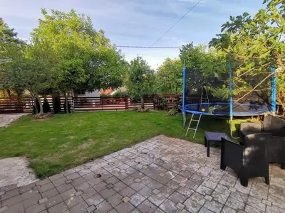 a backyard with a trampoline in the grass at Podinario in Soko Banja