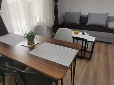 a living room with a table and a couch at Podinario in Soko Banja